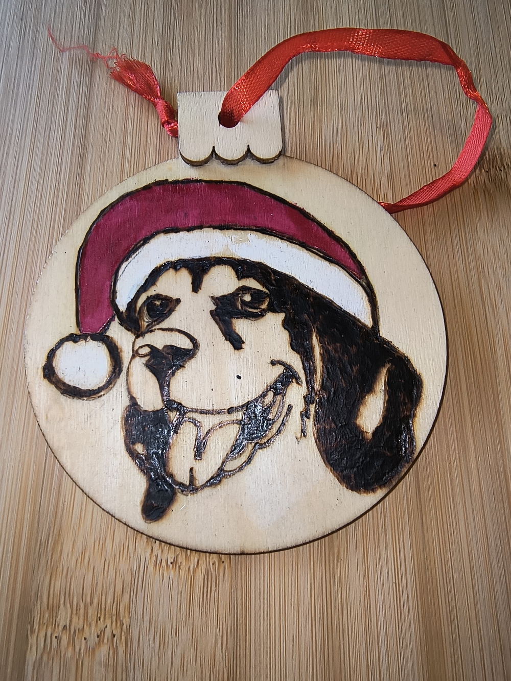 Hand Crafted Wooden Dog Ornament with Red and White Santa Hat